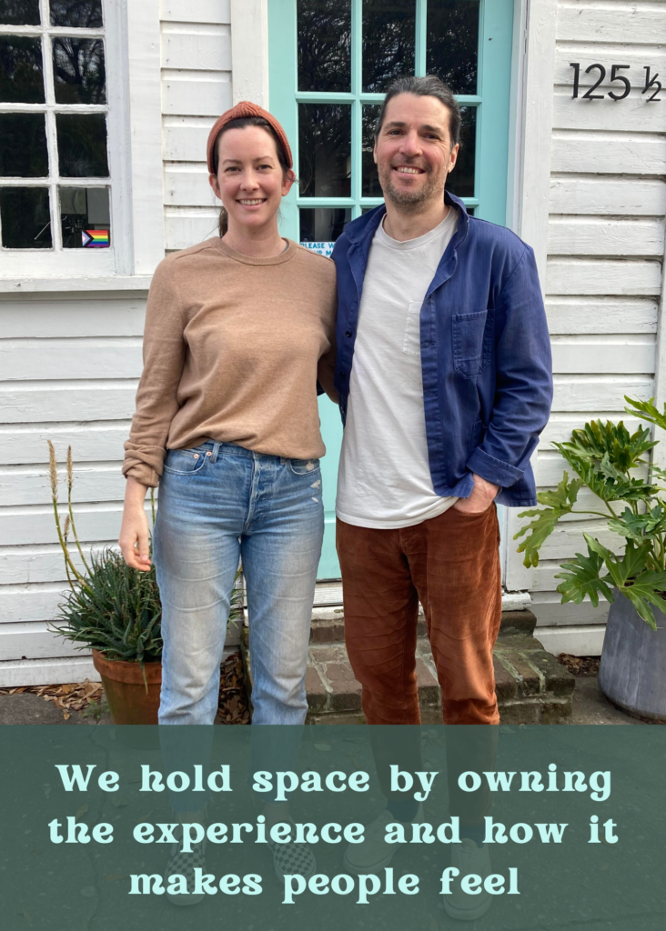 Allyson and Joel of Sightsee shop are smiling outside of their business Sightsee Shop. They are a white man and women who are wearing casual cloths in neutral colors. At the bottom of the picture is a transparent dark green box that contains the quote "We hold space by owning the experience and how it makes people feel."